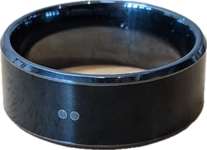 Magic Ring on a wooden surface showing the black ceramic finish and chip marker dots