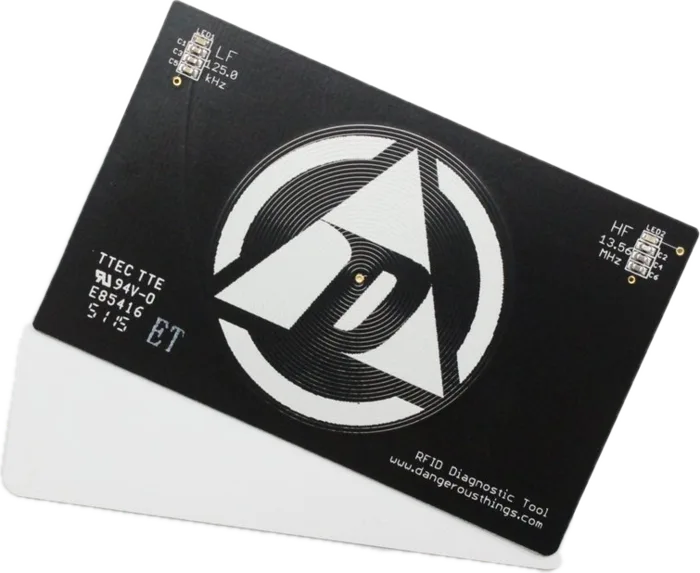 Black RFID Diagnostic Card with the Dangerous Things emblem and LF and HF detector windows, fanned over two blank white cards