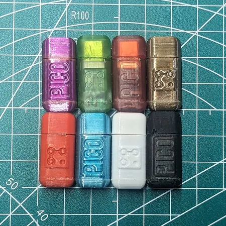 Eight Lodestone PICO USB-C dongles in translucent purple, green, orange, gold, red, blue, white and black