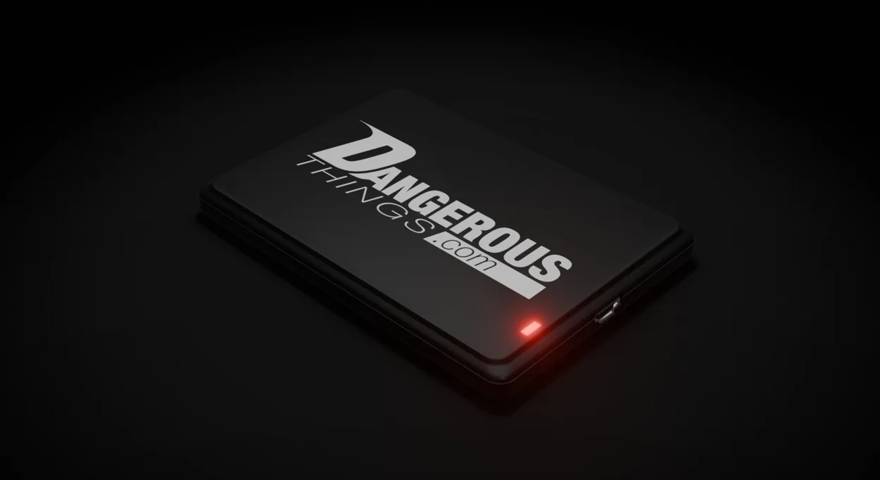 The KBR1, a small black USB reader, with its red status LED lit