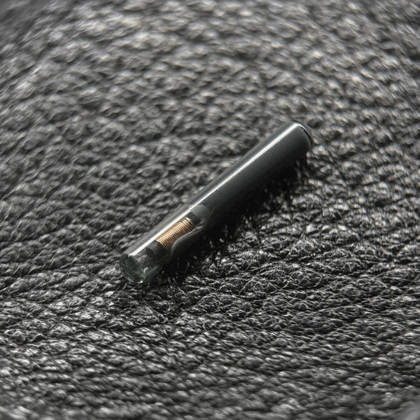 VivoKey Spark 2: a small glass capsule implant with its copper antenna coil visible inside
